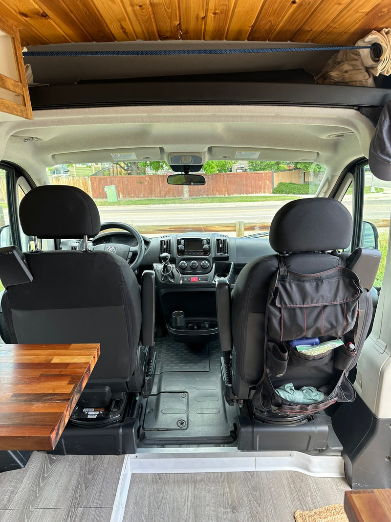 Step inside this RV rental! View of front seats, dashboard, and custom wooden ceiling/storage in a camper van. — photo 16