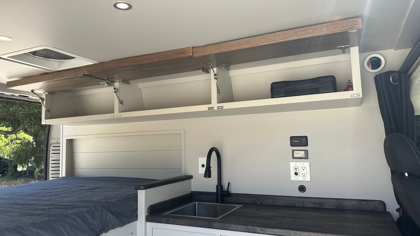  pull-out trash bin and additional storage space in white cabinetry — photo 10