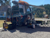 Camper van RV rental set up with bikes, kayak, and awning. A child plays near the open van, perfect for outdoor family travel.