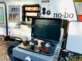 RV rental: Outdoor kitchen with stove, pantry, and paper towel holder for easy camping meals.