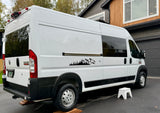 A white Ram ProMaster camper van, ideal for RV rental, with scenic mountain-forest decals parked at home.