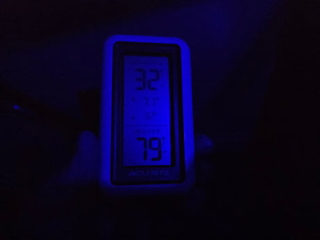 This RV rental's thermometer glows blue, showing 32°F outside and a warm 79°F inside. Cozy comfort on the road.