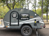Gray Boondock teardrop **rv rental** parked at a campsite, hooked to power. Ideal for outdoor adventures and travel.