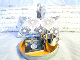 Cozy bed with travel-themed pillows, a 'Pacific Northwest Hiking' guide, & mugs on a tray for your RV rental adventure.