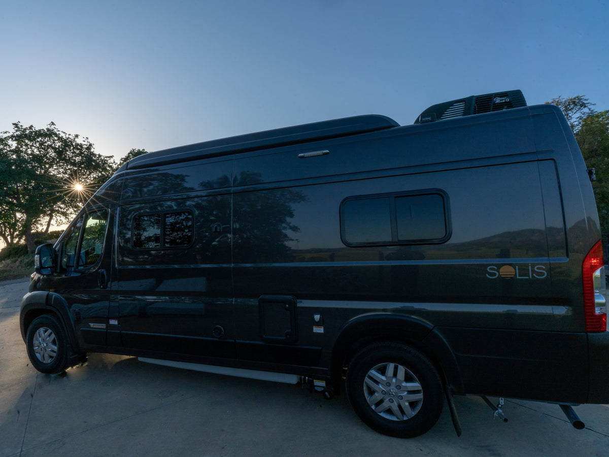 This sleek dark grey Winnebago Solis camper van rv rental is parked at sunset, ready for your next outdoor journey. — photo 8