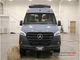 Front view of a gray Mercedes-Benz Sprinter RV, ideal for an RV rental adventure, displayed in a spacious showroom.