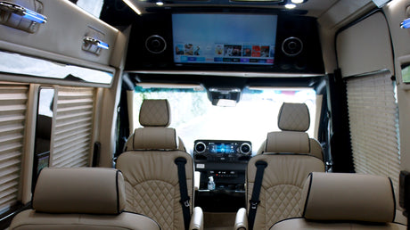 Experience premium rv rental comfort: plush leather interior, entertainment screen, and privacy blinds for your journey.
