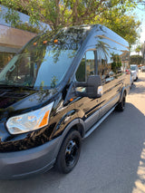 Sleek black Ford Transit passenger van, ideal for RV rental or shuttle services, parked on a bright street.