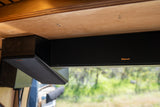 Klipsch soundbar mounted under a wooden ceiling in an RV rental interior for enhanced entertainment.
