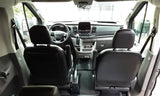 Spacious front cabin of an rv rental van. View of dashboard, steering wheel & seats from the rear.
