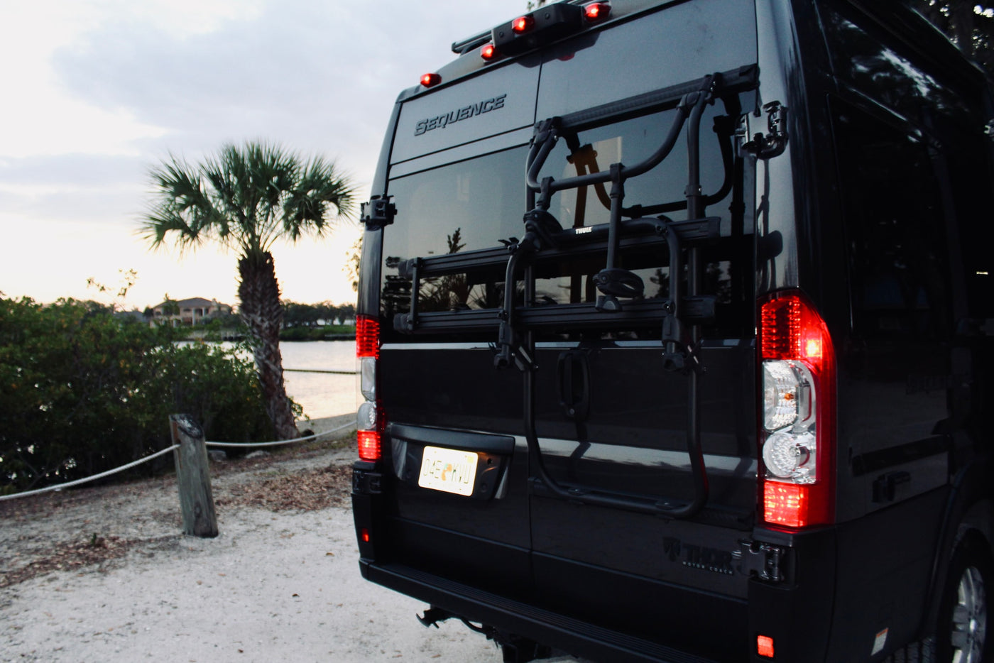 sink with filter. Perfect for travel convenience.|Inside this modern RV rental: light-colored front seats — photo 13