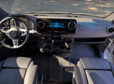 Modern Mercedes Sprinter rv rental interior, featuring spacious dashboard, steering wheel, and intuitive infotainment system.