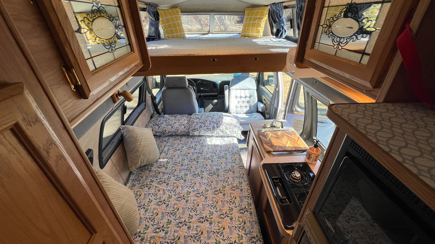  parked with a bike rack & mountain backdrop.|White Coachmen RV rental with two bikes on a rack — photo 5