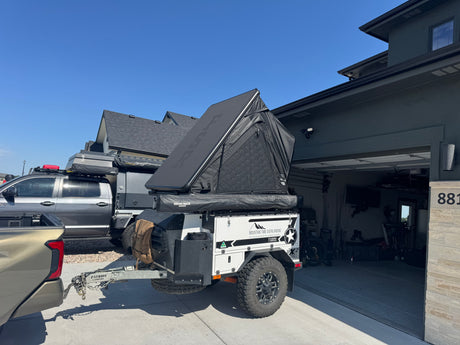 Mountain Time Overlanding RV rental: a Patriot Campers overlanding trailer with a Rhino-Rack rooftop tent, towed by a truck.