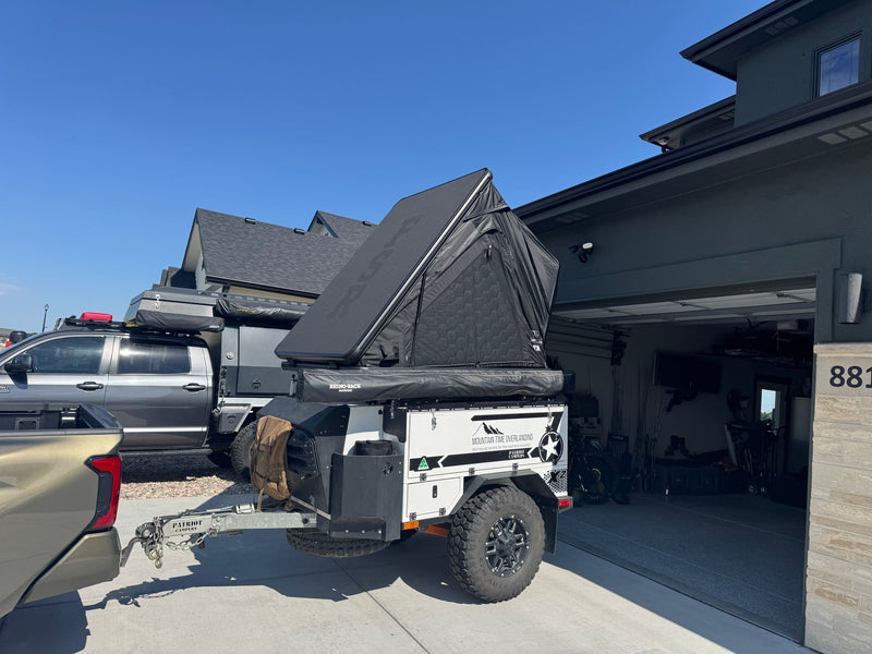 Mountain Time Overlanding RV rental: a Patriot Campers overlanding trailer with a Rhino-Rack rooftop tent, towed by a truck. — photo 2