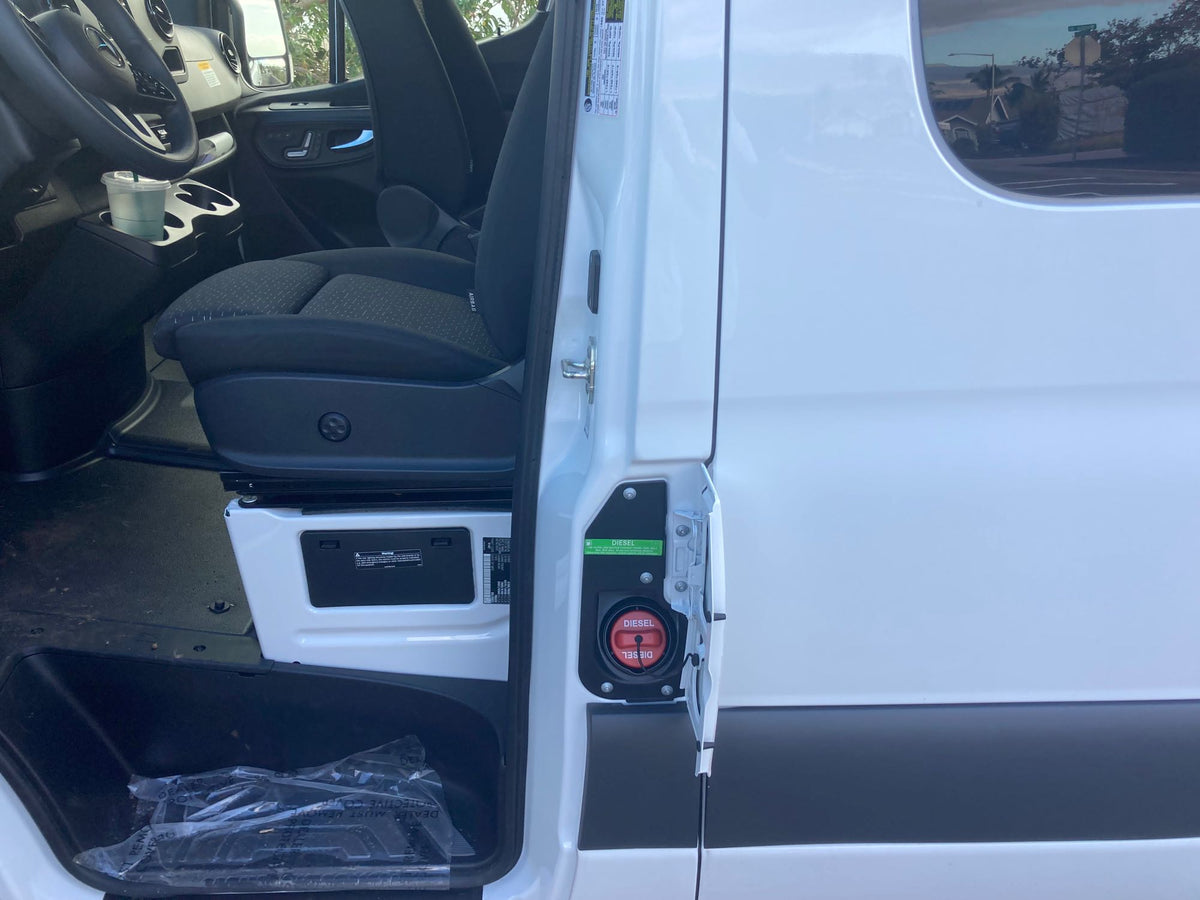  revealing trees and a bright sky.|RV rental: a modern camper van kitchen frames a stunning view of a blue ocean — photo 17