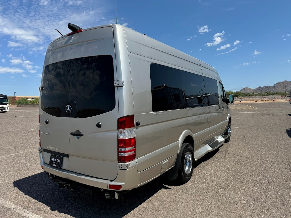 Luxury Ultimate Toys Sprinter van RV rental, shown from the rear in a sunny outdoor lot. — photo 4