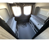 Explore this RV rental's rear interior: two side benches, large windows, providing versatile space for travel.