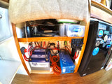 Inside an rv rental: robust Battle Born power system, AIMS inverter, storage for essentials, and a personalized fridge.