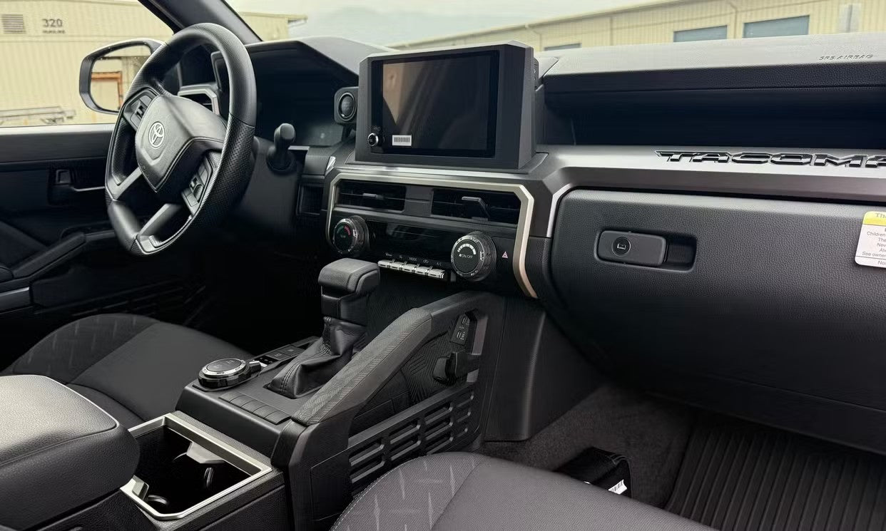 Inside a rugged Tacoma truck, with its digital dashboard, large infotainment screen, and practical center console, perfect for an RV rental trip. — photo 8