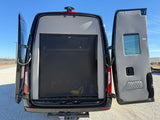 Rear view of an rv rental camper van with open doors revealing a black mesh screen, perfect for airflow.
