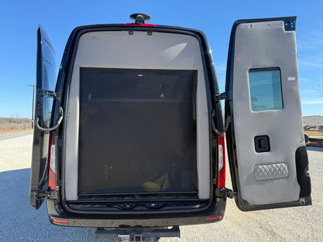 Rear view of an rv rental camper van with open doors revealing a black mesh screen, perfect for airflow.