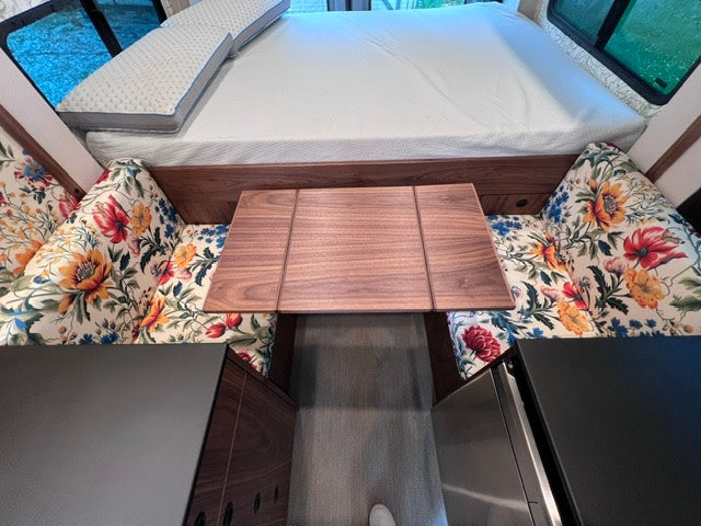  creating a cozy space.|Spacious rv rental interior featuring a main bed with green duvet — photo 7