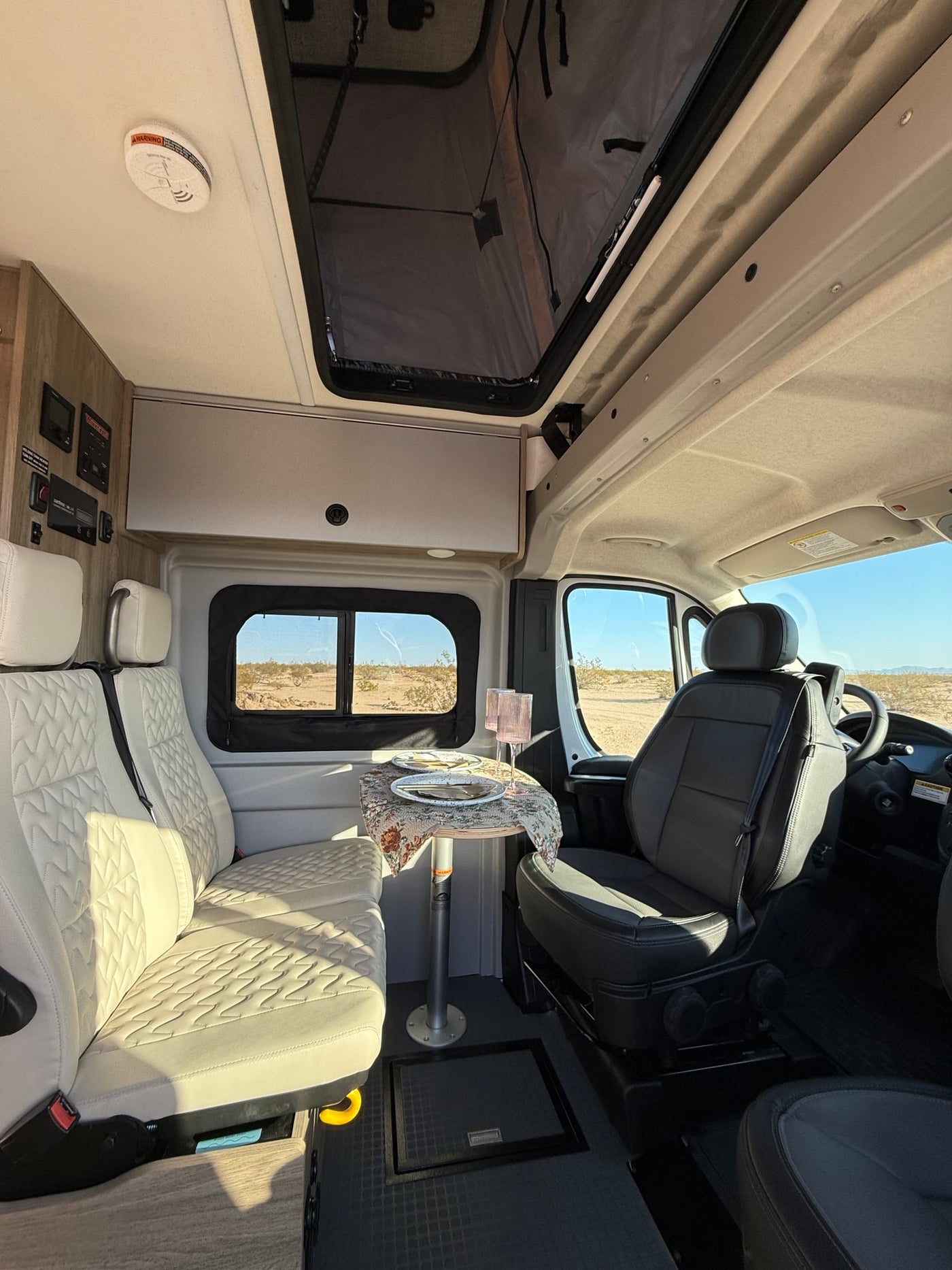  its interior glowing warmly. Chairs invite a cozy evening.|RV rental interior: cozy kitchenette — photo 5
