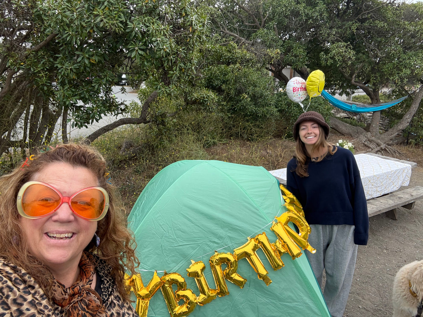 Two women enjoy an outdoor birthday with a tent and decorations. Perfect setup for an RV rental trip! — photo 20