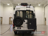 Rear view of a white Winnebago rv rental. Features include a mounted spare tire, roof ladder, and rear storage box.
