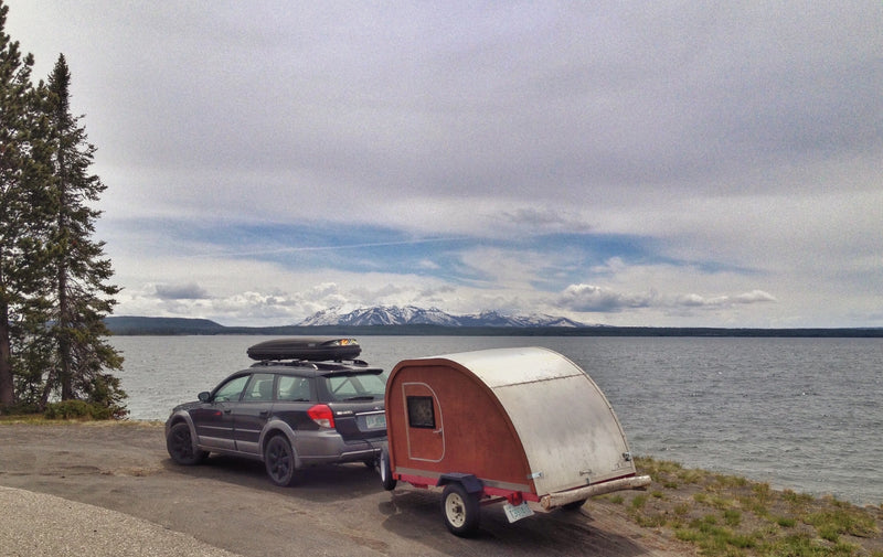 Subaru + teardrop RV rental parked lakeside — photo 1