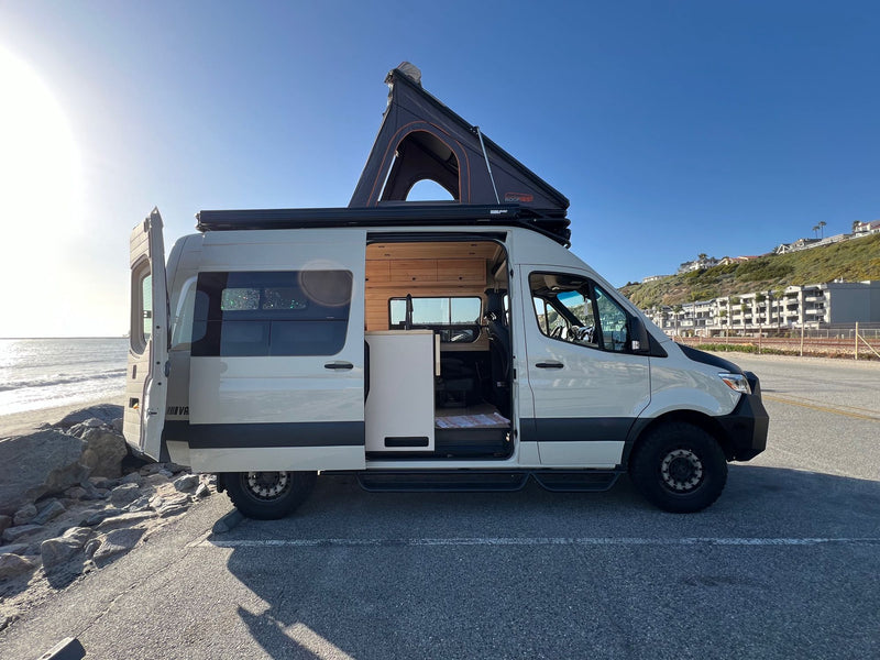  and a window view of a sparkling lake.|Step inside this modern rv rental van conversion — photo 8