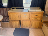  ready for an outdoor adventure among green trees.|RV rental pop-up camper kitchen: sink