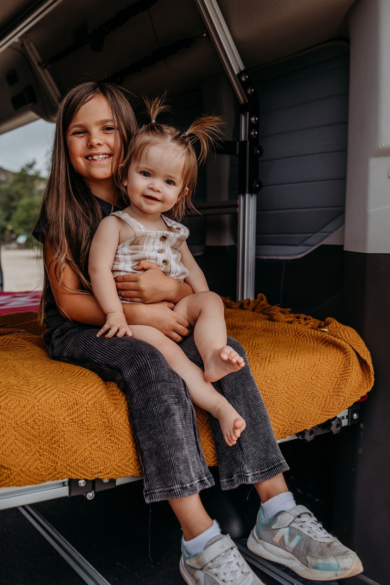 Two happy kids relaxing inside their RV rental. Cozy family travel adventures on the road. — photo 15