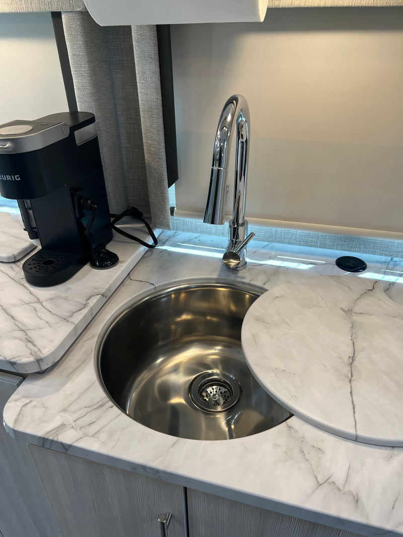 Modern RV rental kitchen: stainless sink, coffee maker, and stylish marble-look countertop. — photo 15