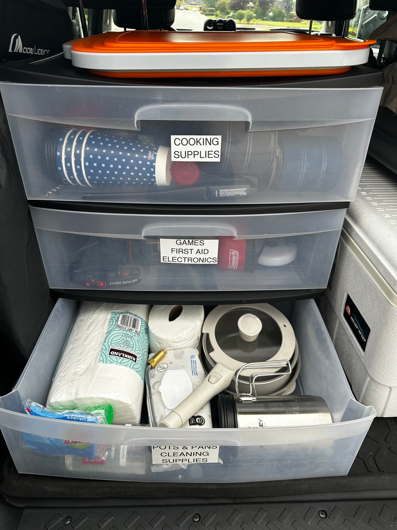 Efficient RV rental organization: clear drawers hold cooking, first aid, electronics, and cleaning supplies for travel. — photo 18