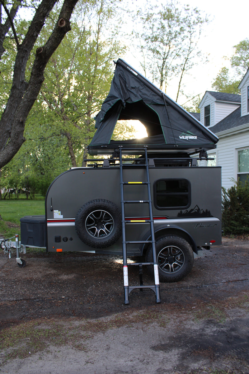 Explore the outdoors with this unique RV rental: a teardrop trailer featuring an open rooftop tent, perfect for camping adventures. — photo 5