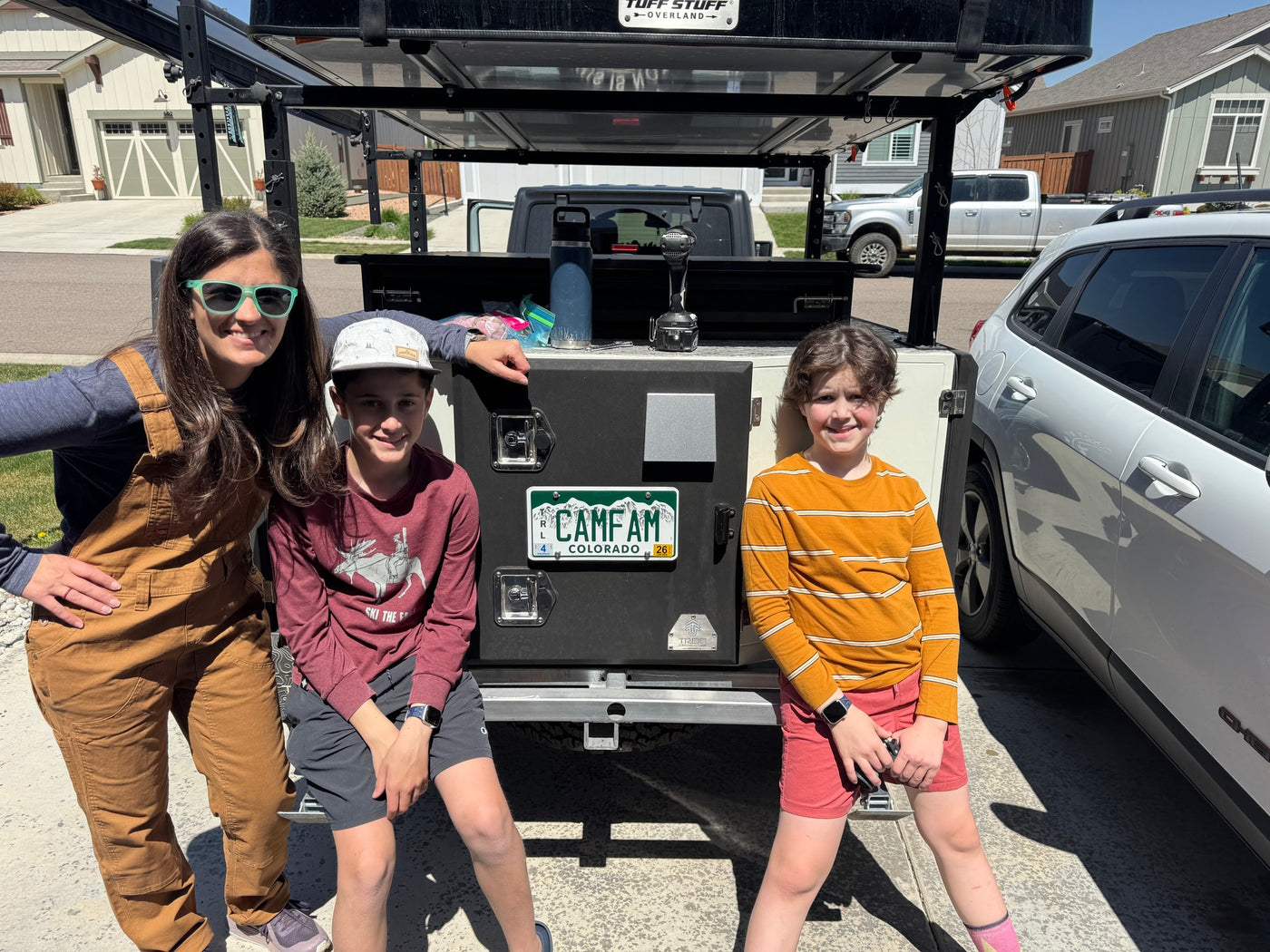 Smiling family with their unique RV rental, an overland camping rig featuring a rooftop tent, ready for adventure in Colorado. — photo 15