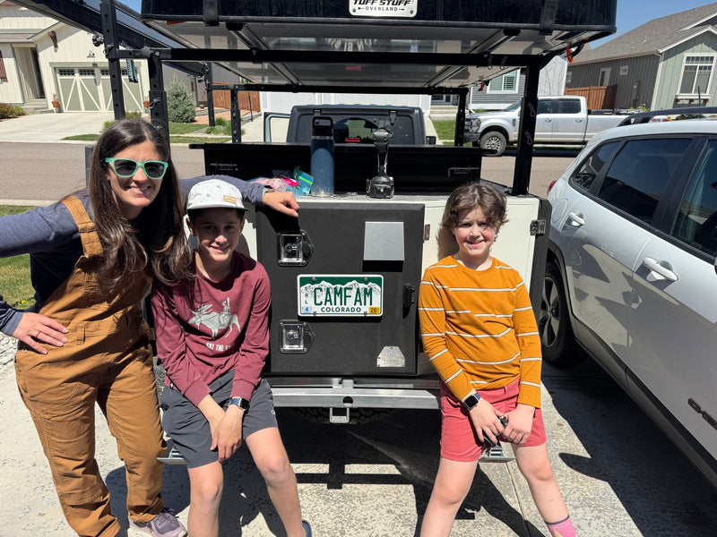 Smiling family with their unique RV rental, an overland camping rig featuring a rooftop tent, ready for adventure in Colorado. — photo 15