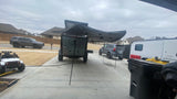 Overland camper, RV, and SUVs on a suburban driveway. Perfect for your next outdoor adventure or RV rental trip.