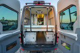 Step into comfort: this RV rental reveals its spacious camper van interior with an elevated bed, ample storage & scenic views.