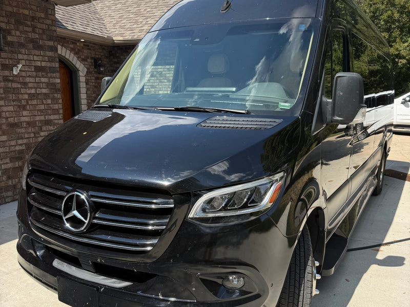 Front view of a sleek black Mercedes-Benz Sprinter van — photo 1