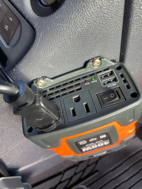 A close-up shows a 400W power inverter mounted in an RV rental, with AC outlet and USB ports for mobile charging.