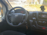 Interior view of a Ram van rv rental, showing the driver's dashboard, steering wheel, and infotainment system display.