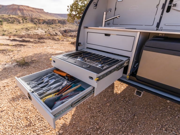  open to a stunning desert mountain landscape.|Enjoy outdoor cooking with an RV rental! This camper's kitchen has a sink — photo 2
