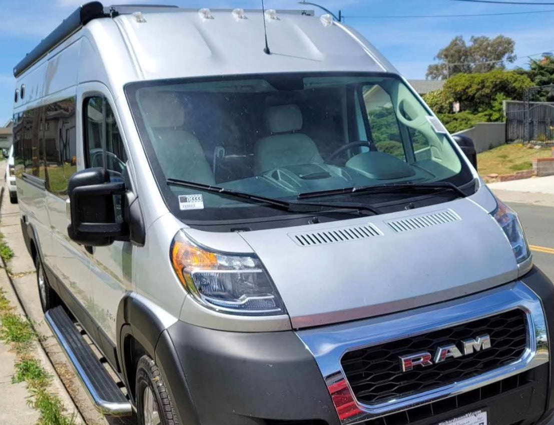 This silver Ram ProMaster RV rental van awaits your next travel adventure.