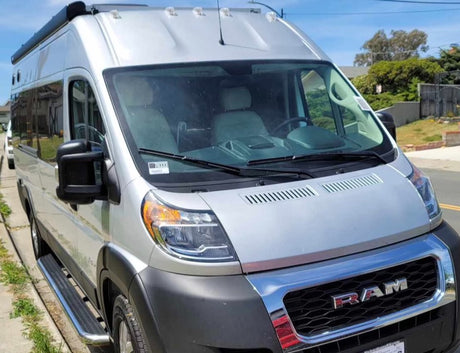 This silver Ram ProMaster RV rental van awaits your next travel adventure.