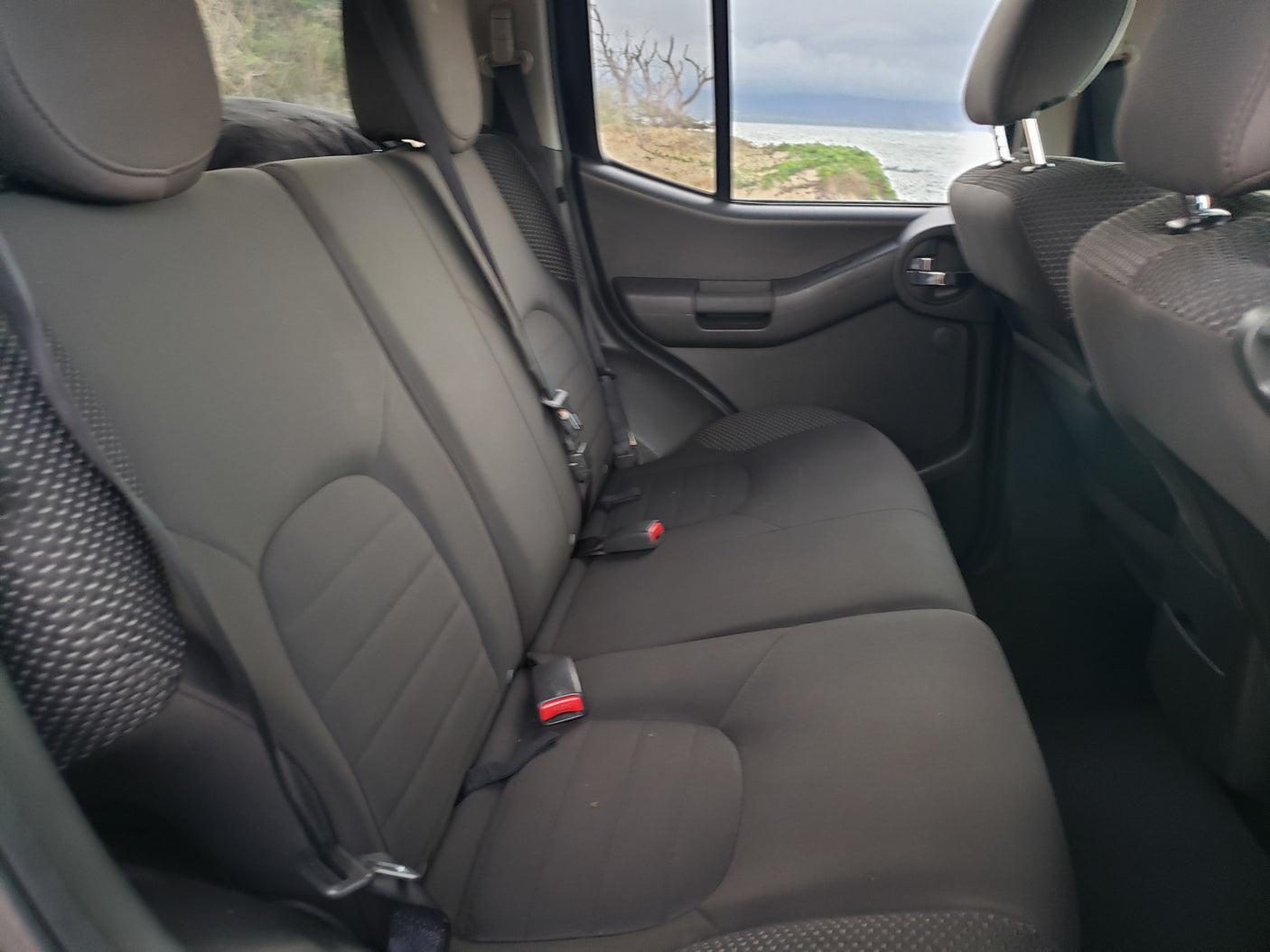 Dark grey vehicle rear seats with coastal view. Great for your next RV rental adventure.