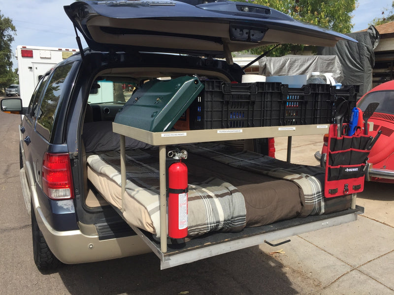 RV rental interior: A car transformed into a comfortable sleeping space with a bed — photo 7