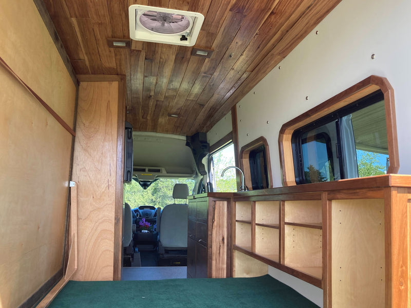  offering serene views of a green landscape.|Step inside this RV rental: a compact kitchen — photo 19